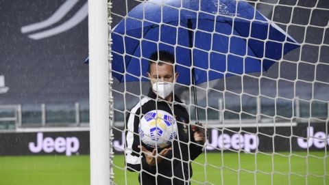 Referee Daniele Doveri inspects the pitch of the Allianz Stadium in Turin, Italy, Sunday, Oct. 4, 2020 ahead of the scheduled Serie A soccer match between Juventus and Napoli. Napoli is likely to be handed a 3-0 loss by the Italian leagues judge for failing to show for its Serie A match at Juventus on Sunday night. Napoli did not travel to Turin for the match after local health authorities ordered the squad into quarantine after two players tested positive for the coronavirus. (Tano Pecoraro/LaPresse via AP)
