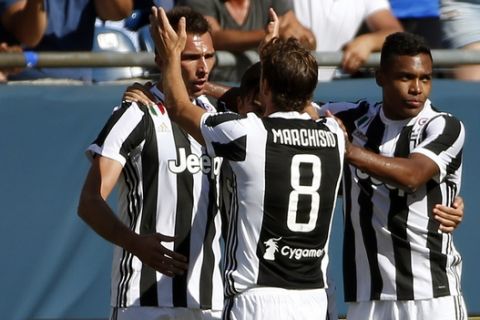 Juventus' Mario Mandzukic, left, celebrates his goal against AS Roma with Claudio Marchisio (8) and Alex Sandro (12) during the first half of an International Champions Cup match, Sunday, July 30, 2017, in Foxborough, Mass. (AP Photo/Michael Dwyer)