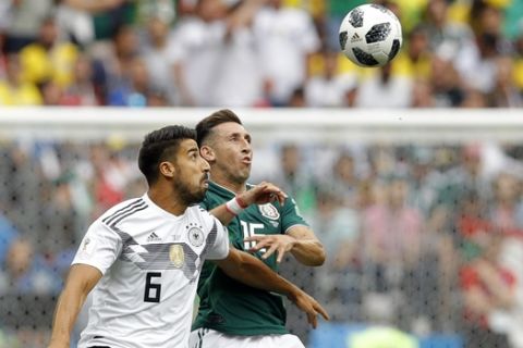 Germany's Sami Khedira, left, fights for the ball with Mexico's Hector Herrera during the group F match between Germany and Mexico at the 2018 soccer World Cup in the Luzhniki Stadium in Moscow, Russia, Sunday, June 17, 2018. (AP Photo/Victor R. Caivano)