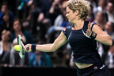 Belgium's Kim Clijsters returns the ball during an exhibition match against Venus Williams from the U.S. at the Sportpaleis in Antwerp, Belgium, Wednesday Dec. 12, 2012.  The four time Grand Slam champion retired from tennis at the US Open this year but wanted to thank her fans with a ceremonial farewell match. The 29-year-old Clijsters retired once before in 2007 to have a baby. She has said that this time there is no chance that she will come back to professional tennis. (AP Photo/Geert Vanden Wijngaert)