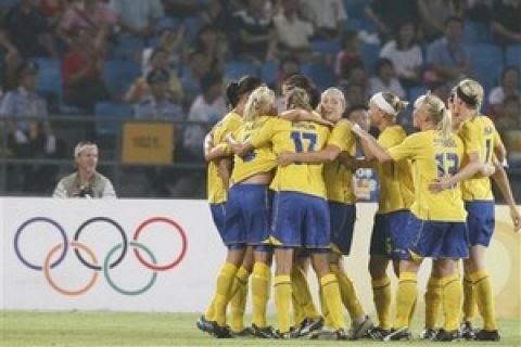 Sweden soccer team  players celebrate after Jessica Landstrom scored against Canada during their Group E women's soccer match at the Beijing 2008 Olympics in Beijing, Tuesday, Aug.12, 2008. (AP Photo/Luca Bruno)