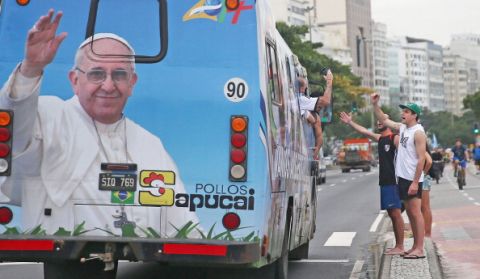 RIO DE JANEIRO, BRAZIL - JULY 11:  An Argentine bus drives past with an image of Pope Francis ahead of their 2014 FIFA World Cup final match against Germany on July 11, 2014 in Rio de Janeiro, Brazil. Up to 100,000 Argentine fans are expected to arrive in Rio for the final match which will be held at the famed Maracana stadium on July 13.  (Photo by Mario Tama/Getty Images)