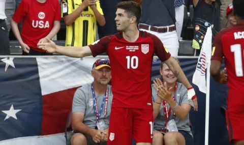 Fans celebrate with U.S. midfielder Christian Pulisic, front, after he scored his second goal against Trinidad & Tobago, in the second half of a World Cup soccer qualifying match Thursday, June 8, 2017, in Commerce City, Colo. The United States won 2-0. (AP Photo/David Zalubowski)