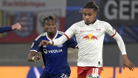 Lyon's Youssouf Kone, left, and Leipzig's Christopher Nkunku challenge for the ball during the Champions League group G first round soccer match between RB Leipzig and Olympique Lyon, in Leipzig, Germany, Wednesday, Oct. 2, 2019. (AP Photo/Jens Meyer)