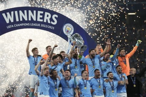 Manchester City's Ilkay Gundogan holds up the trophy after winning the Champions League 
