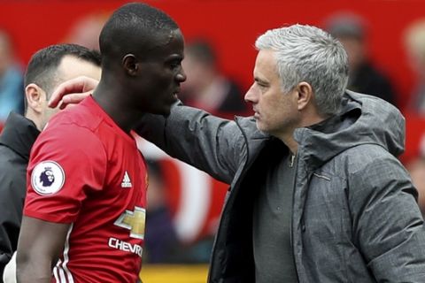 Manchester United's Eric Bailly, left speaks with Manchester United manager Jose Mourinho after suffering an injury during the English Premier League soccer match between Manchester United and Swansea, at Old Trafford, in Manchester, England, Sunday April 30, 2017. (Martin Rickett/PA via AP)