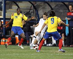 Eric Lichaj #13 of the USA MNT cuts between Falcao Garcia #9 and Adrian Ramos #20 of Colombia during an international friendly match at PPL Park, on October 12 2010 in Chester, PA. The game ended in a 0-0 tie.