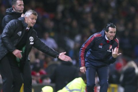 Arsenal's head coach Unai Emery, right, and Manchester United's manager Ole Gunnar Solskjaer, left, give instructions from the side line during the English Premier League soccer match between Manchester United and Arsenal at Old Trafford in Manchester, England, Monday, Sept. 30, 2019. (AP Photo/Dave Thompson)