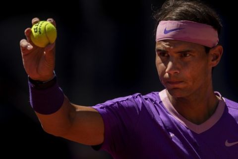 Spain's Rafael Nadal prepares to serve against Spain's Carlos Alcaraz during their match at the Mutua Madrid Open tennis tournament in Madrid, Spain, Wednesday, May 5, 2021. (AP Photo/Bernat Armangue)