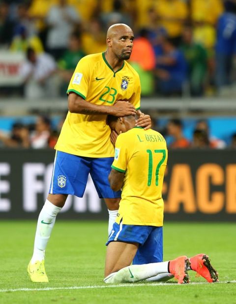 BELO HORIZONTE, BRAZIL - JULY 08:  Maicon consoles Luiz Gustavo of Brazil after Germany's 7-1 win during the 2014 FIFA World Cup Brazil Semi Final match between Brazil and Germany at Estadio Mineirao on July 8, 2014 in Belo Horizonte, Brazil.  (Photo by Martin Rose/Getty Images)