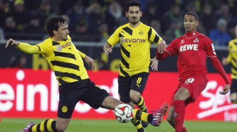 Dortmund's Mats Hummels, left, and Ilkay Gundogan, center, challenge for the ball with Colognes Deyverson during the German first division Bundesliga soccer match between BvB Borussia Dortmnd and 1.FC Cologne in Dortmund, Germany, Saturday, March 14, 2015. (AP Photo/Frank Augstein)