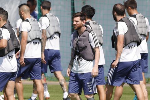 Lionel Messi and teammates work with weight vests during a training session of Argentina at the 2018 soccer World Cup in Bronnitsy, Russia, Saturday, June 23, 2018. (AP Photo/Ricardo Mazalan)