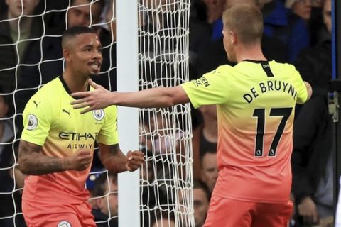 Manchester City's Gabriel Jesus, centre, celebrates scoring his side's first goal of the game against Everton during their English Premier League soccer match at Goodison Park in Liverpool, England, Saturday Sept. 28, 2019. (Peter Byrne/PA via AP)