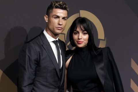 Real Madrid player Cristiano Ronaldo and his girlfriend Georgina Rodriguez pose for photos as they arrive for the Portuguese soccer federation awards ceremony Monday, March 19, 2018, in Lisbon. (AP Photo/Armando Franca)