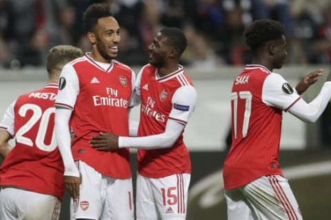 Arsenal's Pierre-Emerick Aubameyang, second left, celebrates after scoring his side's third goal during the Europa League Group F soccer match between Eintracht Frankfurt and Arsenal in the Commerzbank Arena in Frankfurt, Germany, Thursday, Sept. 19, 2019. (AP Photo/Michael Probst)