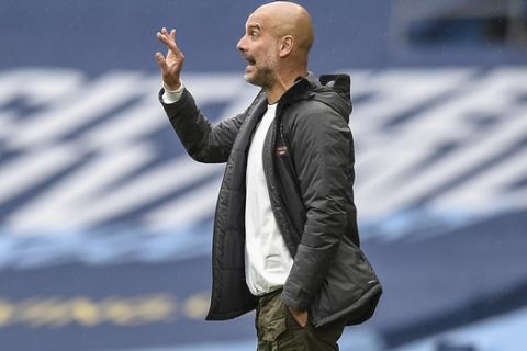 Manchester City's head coach Pep Guardiola gestures during the English Premier League soccer match between Manchester City and Newcastle at the Ethiad Stadium in Manchester, England, Wednesday, July 8, 2020. (Oli Scarff/Pool via AP)