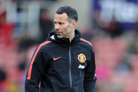 Manchester United's assistant manager Ryan Giggs during their English Premier League soccer match against Stoke City at the Britannia Stadium in Stoke on Trent, England, Thursday Jan. 1, 2015. (AP Photo/Clint Hughes)  