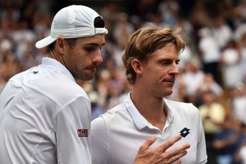 South Africa's Kevin Anderson, right, is congratulated by John Isner of the United States, right, after their men's singles semifinals match at the Wimbledon Tennis Championships, in London, Friday July 13, 2018. (Glyn Kirk/Pool Photo via AP)