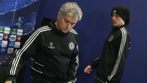 Chelsea coach Jose Mourinho from Portugal, left, and player David Luiz arrive for a press conference at the Vicente Calderon stadium, in Madrid, Spain, Monday April 21, 2014, ahead of the Champions League semifinal first leg soccer match against Atletico Madrid on Tuesday. (AP Photo/Andres Kudacki)
