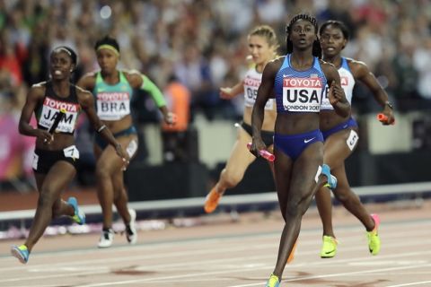 United States' Tori Bowie, right, crosses the line to win the gold in the women's 4x100-meter relay final during the World Athletics Championships in London Saturday, Aug. 12, 2017. (AP Photo/Tim Ireland)