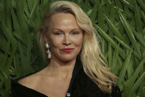 Actress Pamela Anderson poses upon arrival at The British Fashion Awards 2017 in London, Monday, Dec. 4th, 2017. (Photo by Joel C Ryan/Invision/AP)
