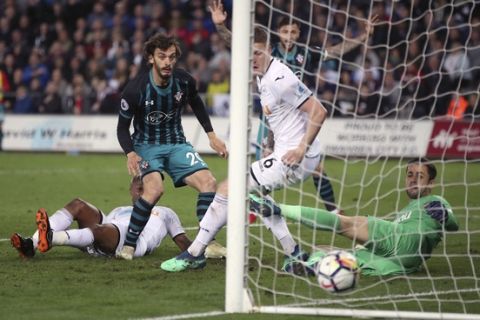 Southampton's Manolo Gabbiadini, second left, scores his side's first goal of the game against Swansea City during the English Premier League soccer match at the Liberty Stadium, Swansea, Wales, Tuesday May 8, 2018. (Nick Potts/PA via AP)