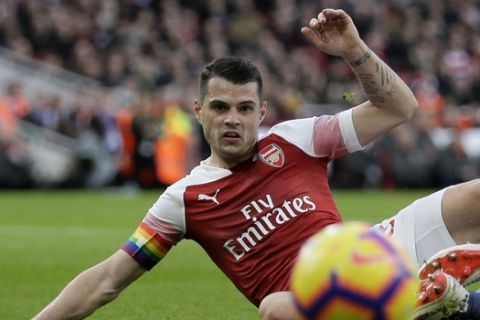 Arsenal's Granit Xhaka fights for the ball with Tottenham's Eric Dier during the English Premier League soccer match between Arsenal and Tottenham Hotspur at the Emirates Stadium in London, Sunday Dec. 2, 2018. (AP Photo/Tim Ireland)