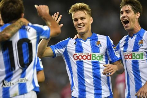 Real Sociedad's Martin Odegaard, center, celebrates after a goal of his team during the Spanish La Liga soccer match between Real Sociedad and Alaves at Reale Arena stadium, in San Sebastian, northern Spain, Thursday, Sept. 26, 2019. (AP Photo/Alvaro Barrientos)