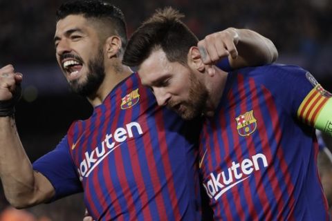 Barcelona's Lionel Messi, right and Barcelona's Luis Suarez celebrate after Messi scored his side's third goal during the Champions League round of 16, 2nd leg, soccer match between FC Barcelona and Olympique Lyon at the Camp Nou stadium in Barcelona, Spain, Wednesday, March 13, 2019. (AP Photo/Emilio Morenatti)