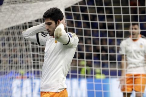 Valencia's Goncalo Guedes, left, reacts after missing a chance to score during the Champions League round of 16, first leg, soccer match between Atalanta and Valencia at the San Siro stadium in Milan, Italy, Wednesday, Feb. 19, 2020. (AP Photo/Luca Bruno)