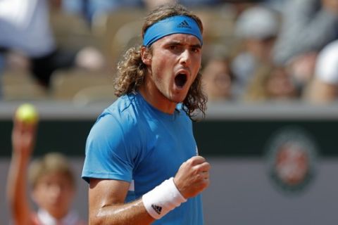 Greece's Stefanos Tsitsipas clenches his fist after scoring a point against Bolivia's Hugo Dellien during their second round match of the French Open tennis tournament at the Roland Garros stadium in Paris, Wednesday, May 29, 2019. (AP Photo/Pavel Golovkin)