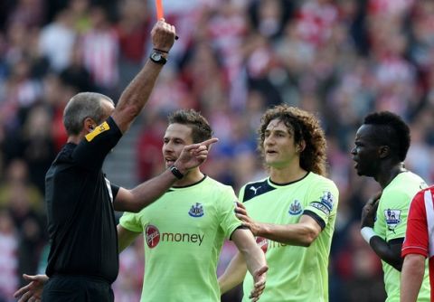 Newcastle United's Chieck Tiote, right, receives a red card from referee Martin Atkinson during their English Premier League soccer match against Sunderland at the Stadium of Light, Sunderland, England, Sunday, Oct. 21, 2012. (AP Photo/Scott Heppell)