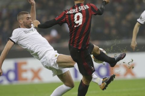 AC Milan's Andre Silva and Athen's Adam Tzanetopoulos vie for the ball during an Europa League, Group D, soccer match between AC Milan and AEK Athens, at the San Siro stadium in Milan, Italy, Thursday, Oct. 19, 2017. (AP Photo/Luca Bruno)