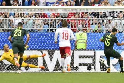 Australia's Mile Jedinak, right, scores his side's opening goal from the penalty spot as Denmark goalkeeper Kasper Schmeichel, left, looks on during the group C match between Denmark and Australia at the 2018 soccer World Cup in the Samara Arena in Samara, Russia, Thursday, June 21, 2018. (AP Photo/Martin Meissner)