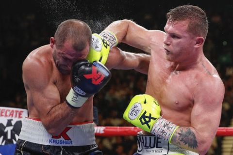 Canelo Alvarez, right, lands a punch against Sergey Kovalev during a light heavyweight WBO title bout, Saturday, Nov. 2, 2019, in Las Vegas (AP Photo/John Locher)