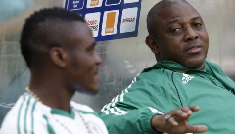 Nigeria's head coach Stephen Keshi, right, talks with player Emmanuel Emenike as he sits on the bench while his teammates train, during a pre-match training session for Nigeria's national soccer team, at Soccer City Stadium in Johannesburg, South Africa, Saturday, Feb. 9, 2013. Nigeria will face Burkina Faso Sunday, Feb. 10, at Soccer City in the African Cup of Nations tournament final. (AP Photo/Rebecca Blackwell)