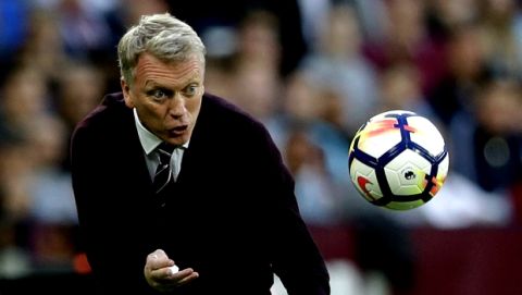 West Ham United's David Moyes throws the ball back to a player after it went out during the English Premier League soccer match between West Ham United and Manchester United at the London Stadium in London, Thursday, May 10, 2018. (AP Photo/Alastair Grant)