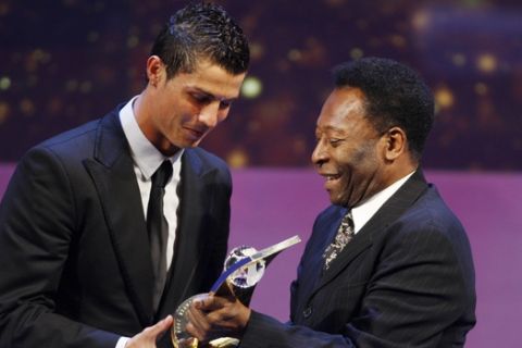 Soccer player Cristiano Ronaldo from Portugal, left, receives the trophy from former Brazilian soccer star Pele, right, after being named FIFA World Player of the Year during the FIFA World Player Gala 2008 at the Opera house in Zurich, Switzerland, Monday, Jan.12, 2009. (AP Photo/KEYSTONE/Steffen Schmidt) 