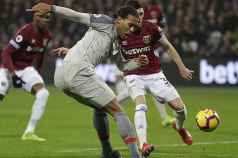 Liverpool's Virgil van Dijk shoots on goal during the English Premier League soccer match between West Ham United and Liverpool at the London Stadium in London, Monday, Feb. 4, 2019.(AP Photo/Kirsty Wigglesworth)