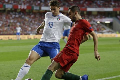 Italy's Mattia Caldara, left and Portugal's Bernardo Silva challenge for the ball during the UEFA Nations League soccer match between Portugal and Italy at the Luz stadium in Lisbon, Monday, Sept. 10, 2018. (AP Photo/Armando Franca)