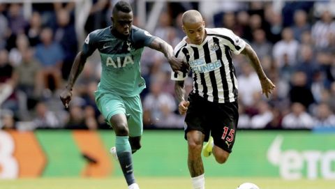 Newcastle United's Kenedy, right, and Tottenham Hotspur's Davinson Sanchez run for the ball during their English Premier League soccer match at St James' Park in Newcastle, England, Saturday Aug. 11, 2018. (Owen Humphreys/PA via AP)