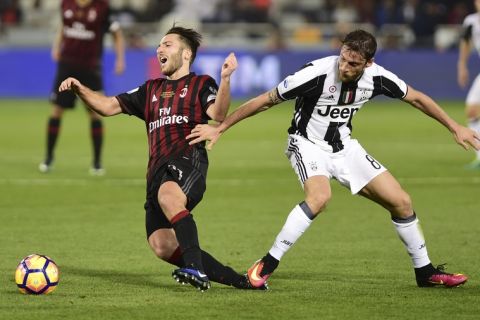 AC Milan's Andrea Bertolacci, left, is challenged by Juventus's Claudio Marchisio during the Italian Super Cup soccer match between Juventus and AC Milan, at the Al Sadd Sports Club in Doha, Qatar, Friday, Dec. 23, 2016. (AP Photo/Alexandra Panagiotidou)