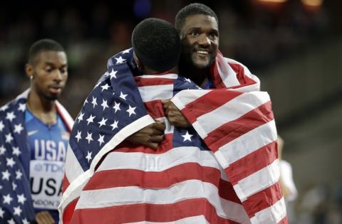 United States Justin Gatlin embraces one of his teammates after the Men's 4x100m relay final in which the US took the silver medal during the World Athletics Championships in London Saturday, Aug. 12, 2017. (AP Photo/David J. Phillip)