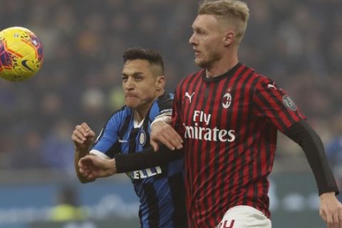 Inter Milan's Alexis Sanchez, left, vies for the ball with AC Milan's Simon Kjaer during the Serie A soccer match between Inter Milan and AC Milan at the San Siro Stadium, in Milan, Italy, Sunday, Feb. 9, 2020. (AP Photo/Antonio Calanni)