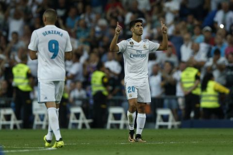 Real Madrid's Marco Asensio, right, celebrates after scoring his side's second goal against Valencia during a Spanish La Liga soccer match between Real Madrid and Valencia at the Santiago Bernabeu stadium in Madrid, Sunday, Aug. 27, 2017. (AP Photo/Francisco Seco)