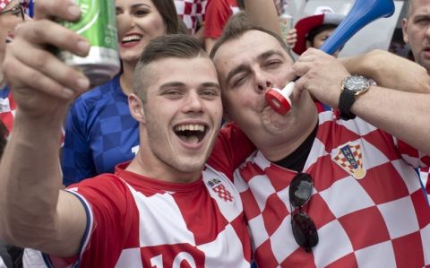 Croatian soccer fans jubilate before the start of the World Cup final in central Zagreb, Croatia, Sunday, July 15, 2018. Croatia's national soccer team faces France in the World Cup final in Russia. (AP Photo/Marko Drobnjakovic)