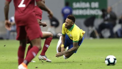 Brazil's Neymar, right, gestures after being fouled during a friendly soccer match against Qatar at the Estadio Nacional in Brasilia, Brazil, Wednesday, June 5, 2019. Brazil and Qatar are preparing for the Copa America which runs from June 14 until July 7 in Brazil. (AP Photo/Eraldo Peres)