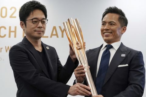 The Olympic torch of the Tokyo 2020 Olympic Games is unveiled during a press conference in Tokyo Wednesday, March 20, 2019. The torch is the centerpiece of attention in the months just before the Olympics open. The Tokyo Olympics open on July 24, 2020. (AP Photo/Eugene Hoshiko)
