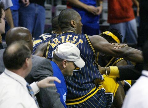 Indiana Pacers forward Ron Artest (91) goes into the stands in an altercation with fans Friday, Nov. 19, 2004, in Auburn Hills, Mich.  The Pacers' leadership voiced their support for Ron Artest and the other players suspended after the brawl with Detroit Pistons fans and apologized for their role in one of the most violent exchanges between players and fans in U.S. sports history.  (AP Photo/Duane Burleson) 