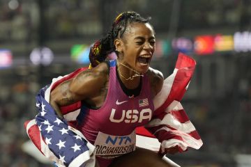 Sha'Carri Richardson, of the United States, shouts out as she celebrates with her gold medal for winning the women's 100 meters during the World Athletics Championships in Budapest, Hungary, Monday, Aug. 21, 2023. (AP Photo/Ashley Landis)